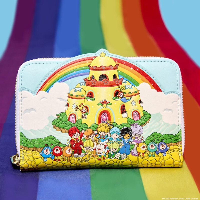 Loungefly Rainbow Brite Color Castle Zip Around Wallet sitting on a rainbow against a blue background, featuring Color Castle and the Color Kids